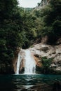 Vertical photo of a high mountain river waterfall Royalty Free Stock Photo