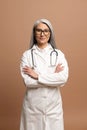 Headshot of intelligent professional Asian female doctor with gray hair, wearing glasses Royalty Free Stock Photo
