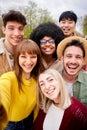 Vertical photo of large group of cheerful young friends taking selfie portrait outdoor. Royalty Free Stock Photo