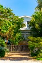 Vertical photo luxury house with sea grape tree and palms