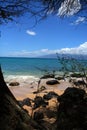 Vertical photo of Many Lava and tree frame Mountains inside a ocean in Hawaii