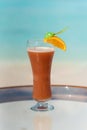 Vertical photo of Mrs. Robinson Seltzer cocktail on the glass table ocean background at the beach Royalty Free Stock Photo