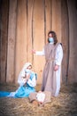 Vertical photo of nativity scene with the characters wearing masks