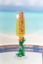 Vertical photo of new year holiday tropical cocktail on the glass table at the beach with ocean Royalty Free Stock Photo