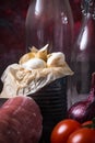 Detail of white garlic cloves next to pork tenderloin on wooden board Royalty Free Stock Photo