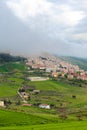 Vertical photo of picturesque Sicilian village Gangi in Italy captured in fog. The small historical city is surrounded by green Royalty Free Stock Photo