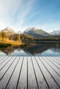 Vertical photo - pier on the lake in autumn scenery and beautiful and snowy mountains on background. Strbske pleso in High Tatras Royalty Free Stock Photo