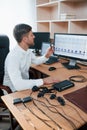 Vertical photo. Polygraph examiner works in the office with his lie detector`s equipment