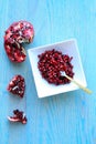 Vertical photo of pomegranate fruits inside a white bowl