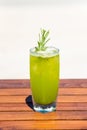 Vertical photo of refreshing cucumber juice cocktail on wooden table at the beach Royalty Free Stock Photo