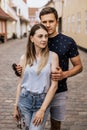 Vertical photo of romantic couple are stand in embrance with city background