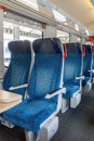 Vertical photo - Row of blue empty train seats in Czech train. Empty blue seats inside train cabin, corridor view, no Royalty Free Stock Photo