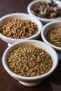 Vertical photo of selective focus on the bowl with cumin