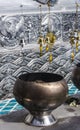 Small golden bells and Bodhi Tree leaves hanging in a wire above Donation Bowl in Wat Sri Suphan Buddhist Temple