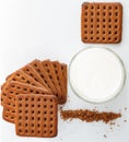 vertical photo. square chocolate chip cookies, cookie crumbs with glass of milk on white background Royalty Free Stock Photo