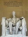 Vertical photo of the statue of Abraham Lincoln sitting on a chair at the National Mall Memorial in Washington DC. Royalty Free Stock Photo