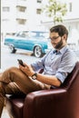 Vertical photo of stylish man working with phone