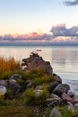 Calm fall evening with pink clouds at seawall. Royalty Free Stock Photo