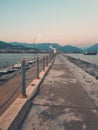 vertical photo at sunset road to lighthouse against backdrop of the sea and mountains. Alanya Turkiye. soft focus. Royalty Free Stock Photo