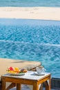 Vertical photo of tropical breakfast at pool in the resort Royalty Free Stock Photo