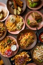 Vertical photo various of food on cafe table. Italian, american food platesm junk and snack food. Top view, full frame