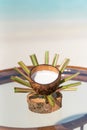 Vertical photo of virgin coconut with milk on the glass table at the beach with ocean