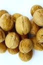 Walnuts lie in a pile on a white background Royalty Free Stock Photo