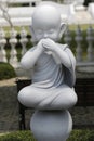 Monumental White Statue of a Monk Covering his Mouth