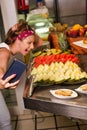 Vertical photo of a woman with an open mouth and a hungry expression in front of an assortment of fruit making a selfie with the Royalty Free Stock Photo