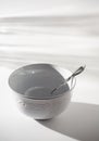 Empty White Bowl with Spoon on a White Background Royalty Free Stock Photo