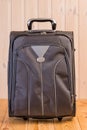 Vertical photograph of a gray big closed suitcase