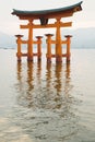 Vertical photograph of the great torii of Miyajima surrounded by water