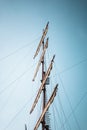 A vertical shot of a ship mast with a blue sky in the background Royalty Free Stock Photo