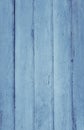 Vertical photograph of old wooden planks painted with blue paint that has cracked and fallen off in places due to weather and time Royalty Free Stock Photo