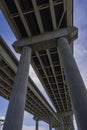 View Underneath a Large Bridge Highway on a Sunny Day with Blue Sky