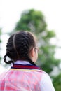 Vertical photos. Braided girl stood back and looked to the front. Children wearing graduation gowns in kindergarten.