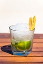 Vertical photos of tropical icy cocktail with fruits on the wooden table at the beach Royalty Free Stock Photo