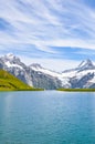 Vertical picture of amazing Bachalpsee near Grindelwald in Swiss Alps photographed with famous mountain peaks Eiger, Jungfrau, and