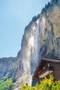 Vertical picture of beautiful Staubbach Falls in Lauterbrunnen, Switzerland. Amazing waterfall in popular Alpine village. Tourist Royalty Free Stock Photo