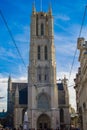 Vertical picture of the facade of Saint Bavo Cathedral Sint-Baafskathedraal in Sint-Baafsplein in Ghent, Belgium, during a sunny