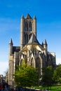 Vertical picture of the facade of Saint Nicholas` Church Sint-Niklaaskerk in a sunny day with green trees of Emile Braunplein a