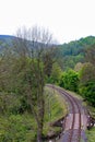 Vertical picture of the landscape outside of Loket, in Czech Republic, with green vegetation and old train tracks Royalty Free Stock Photo