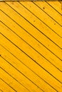 Obsolete yellow painted wooden background texture. Outdoor, macro