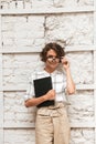 Vertical picture of Pensive curly female manager Royalty Free Stock Photo