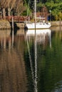 Vertical picture of a reflection of a white boat at daytime