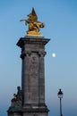 Vertical picture of the Statue of a Fame on the Pont Alexandre III in the evening in Paris, France
