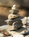 Vertical picture of stones on top of each other under the sunlight with a blurry background Royalty Free Stock Photo