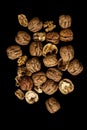 Vertical picture of walnuts under the lights against a black background