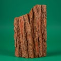 A vertical piece of rugged tree bark stands against a plain green background. The bar Royalty Free Stock Photo