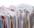 Vertical pile of newspapers and flyers